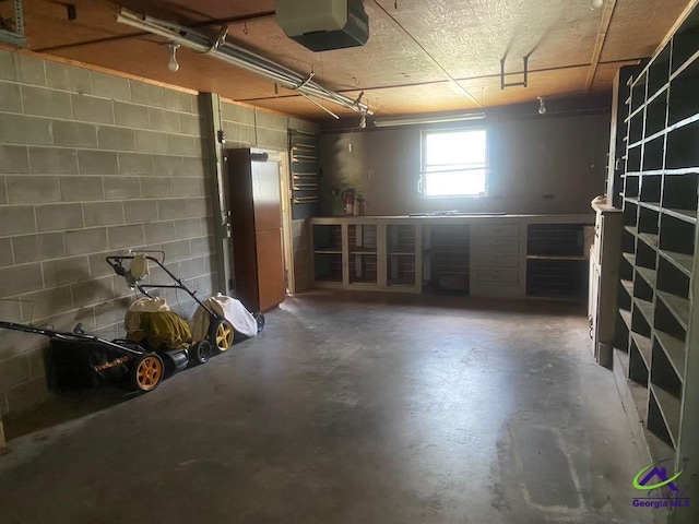 5864 Porterfield Cir, Macon, GA 31216 - garage with a garage door opener and concrete block wall