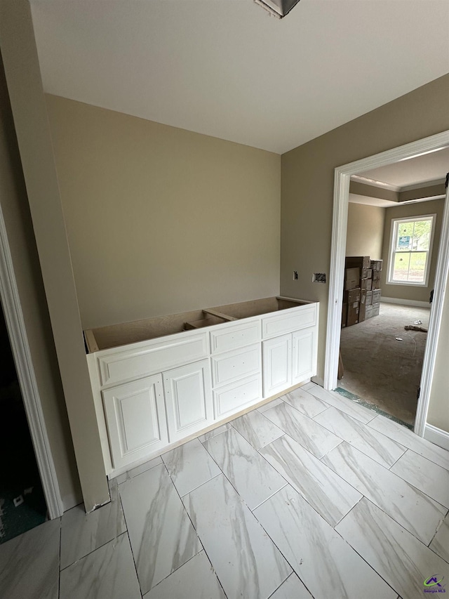 empty room featuring light marble finish floors