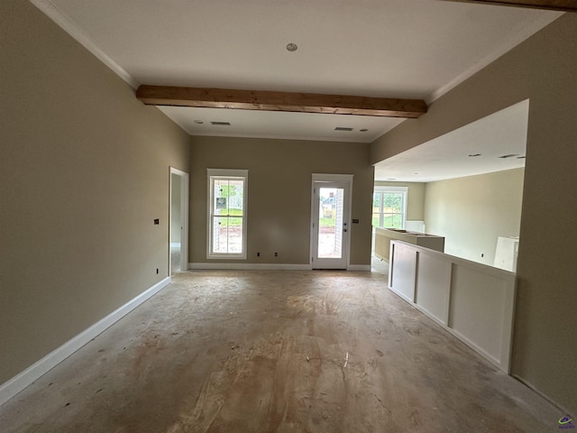 unfurnished living room with baseboards, healthy amount of natural light, and beamed ceiling