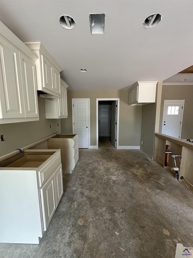 kitchen with white cabinetry and baseboards
