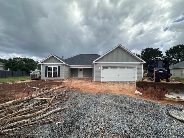 view of front of home with a garage, fence, driveway, and board and batten siding