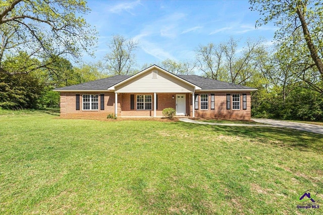 ranch-style home featuring a front lawn, brick siding, and covered porch