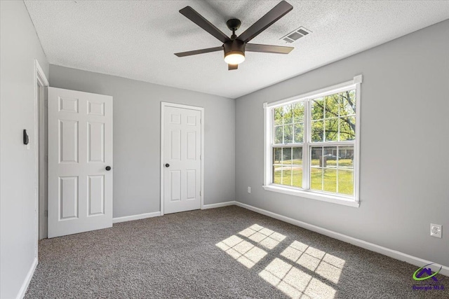 unfurnished bedroom with baseboards, visible vents, and a textured ceiling