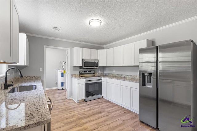 kitchen with crown molding, electric water heater, a sink, stainless steel appliances, and visible vents