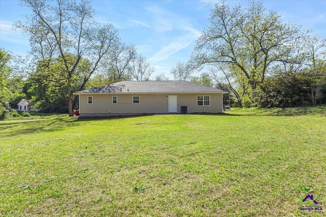 back of property featuring a lawn