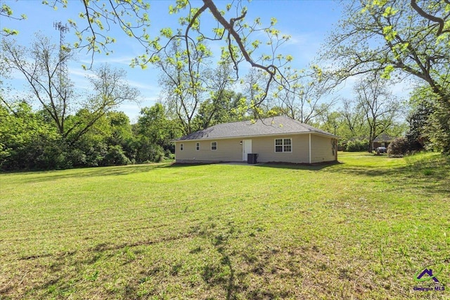 back of property featuring a lawn