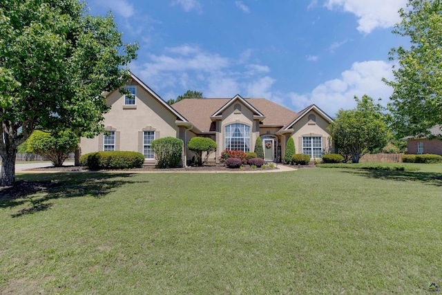 102 Harvester Ln, Bonaire, GA 31005 - ranch-style house with a front yard and stucco siding
