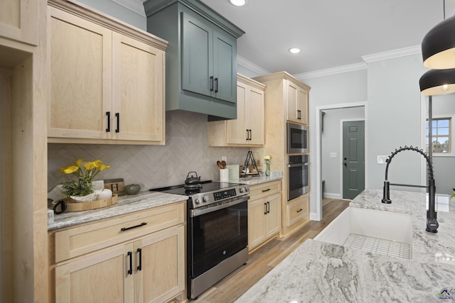 kitchen featuring crown molding, appliances with stainless steel finishes, a sink, decorative backsplash, and light brown cabinets