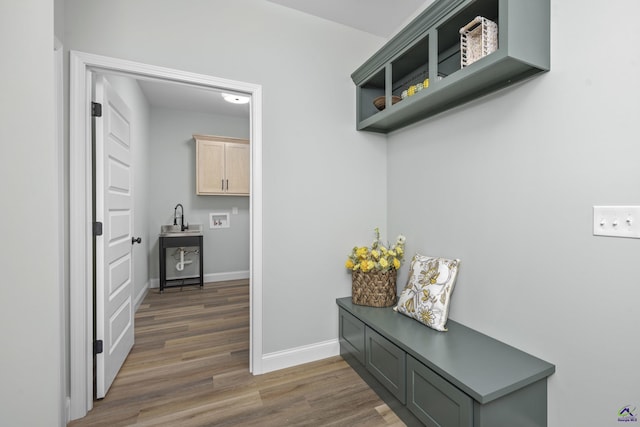 mudroom featuring baseboards and wood finished floors