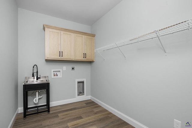 laundry area featuring hookup for an electric dryer, dark wood-type flooring, hookup for a washing machine, cabinet space, and a sink