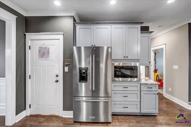 kitchen with built in microwave, recessed lighting, high end fridge, ornamental molding, and dark wood-style flooring