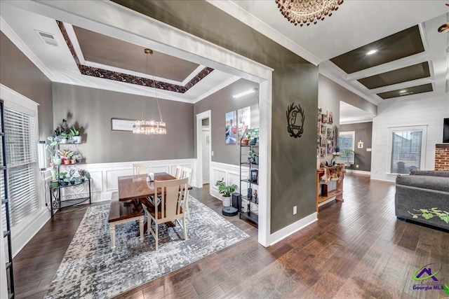 dining room featuring dark wood-style flooring, baseboards, an inviting chandelier, coffered ceiling, and ornamental molding