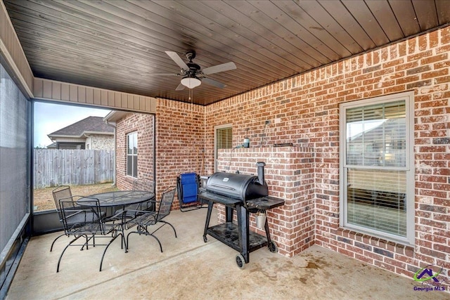 view of patio featuring fence, a ceiling fan, outdoor dining space, and a grill