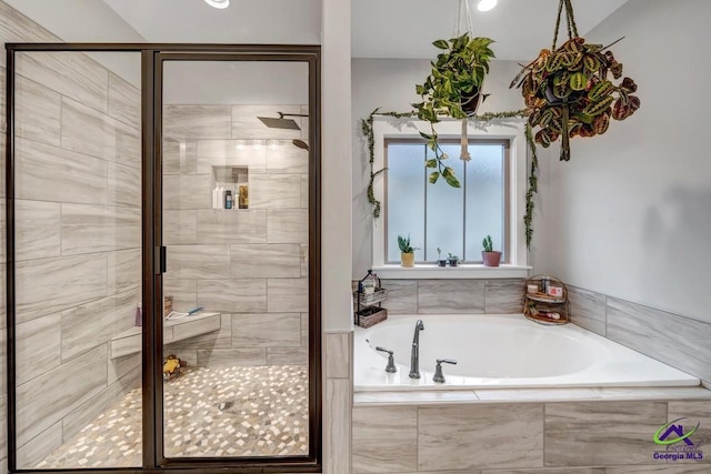 full bathroom featuring a bath and a shower stall