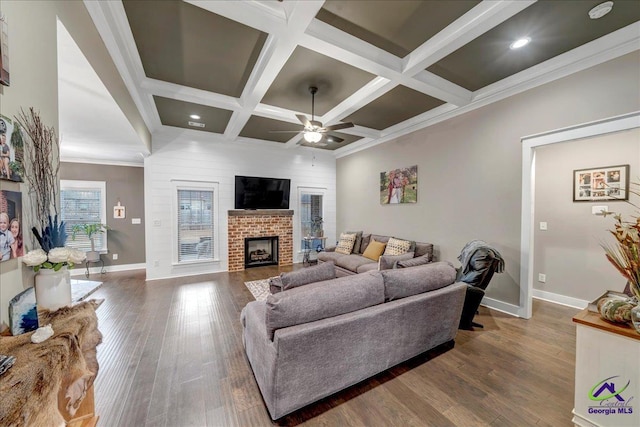 living area featuring a brick fireplace, baseboards, ceiling fan, and coffered ceiling