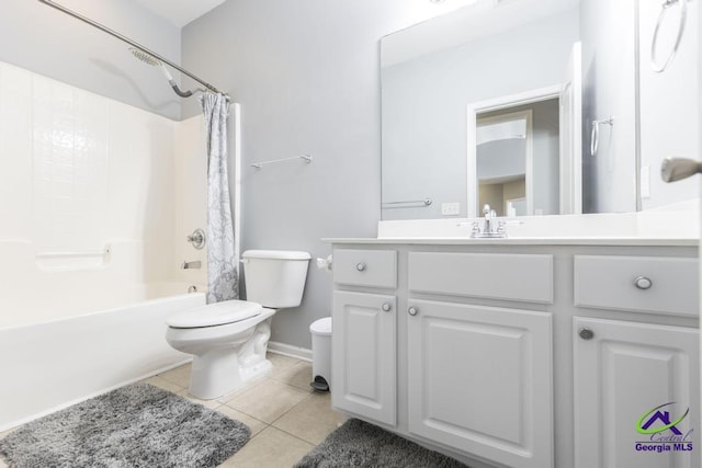 bathroom with tile patterned floors, toilet, vanity, shower / bath combo with shower curtain, and baseboards