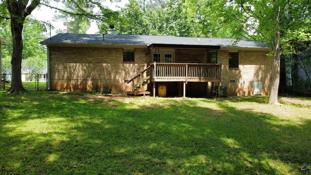 2045 Greentree Pkwy, Macon, GA 31220 - rear view of house with a wooden deck, brick siding, and a yard
