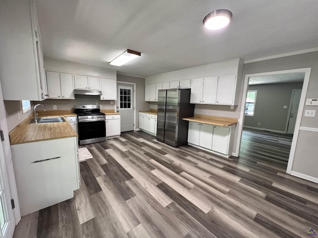 2045 Greentree Pkwy, Macon, GA 31220 - kitchen featuring butcher block counters, under cabinet range hood, stainless steel appliances, and a sink
