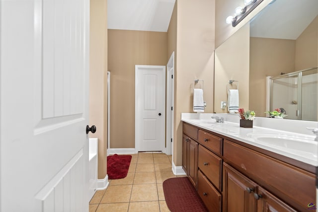 bathroom with a shower stall, tile patterned flooring, a sink, and double vanity