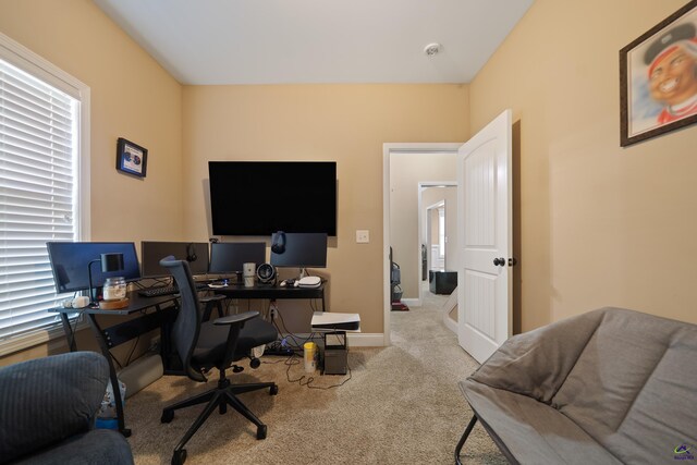 carpeted office space with baseboards