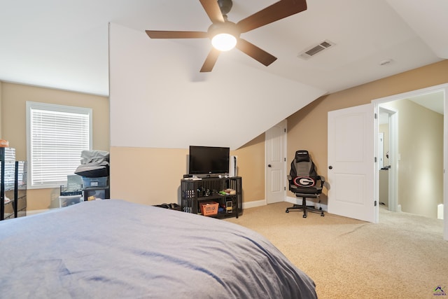 carpeted bedroom featuring ceiling fan, lofted ceiling, and visible vents