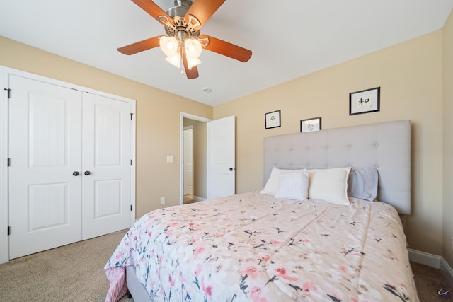 bedroom with a ceiling fan, baseboards, a closet, and carpet