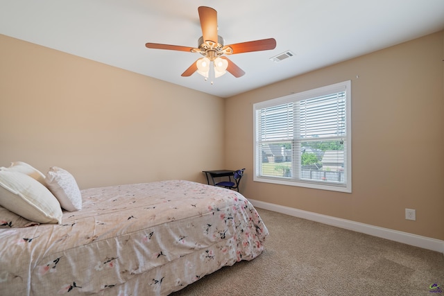 bedroom with visible vents, carpet flooring, baseboards, and ceiling fan