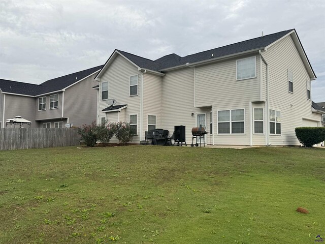101 Bryce Dr, Warner Robins, GA 31088 - back of house with a lawn and fence