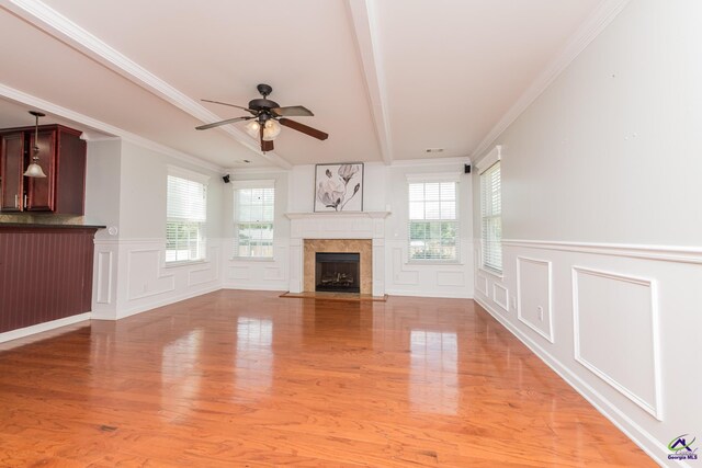 101 Bryce Dr, Warner Robins, GA 31088 - unfurnished living room featuring beam ceiling, a decorative wall, a healthy amount of sunlight, and a ceiling fan