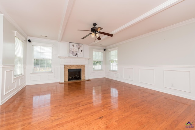101 Bryce Dr, Warner Robins, GA 31088 - unfurnished living room featuring wood finished floors, ceiling fan, a fireplace with flush hearth, and a decorative wall