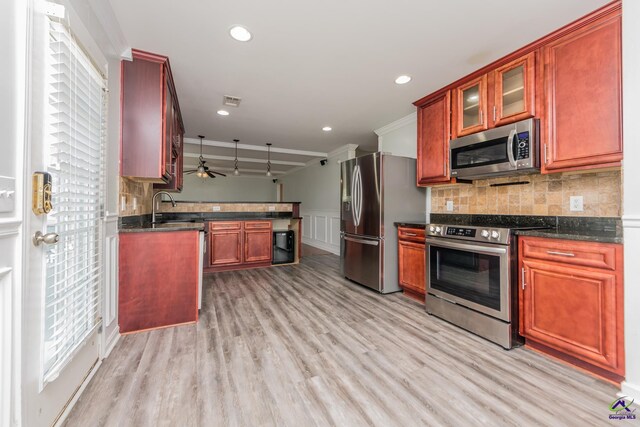 101 Bryce Dr, Warner Robins, GA 31088 - kitchen featuring tasteful backsplash, glass insert cabinets, light wood-style floors, and appliances with stainless steel finishes