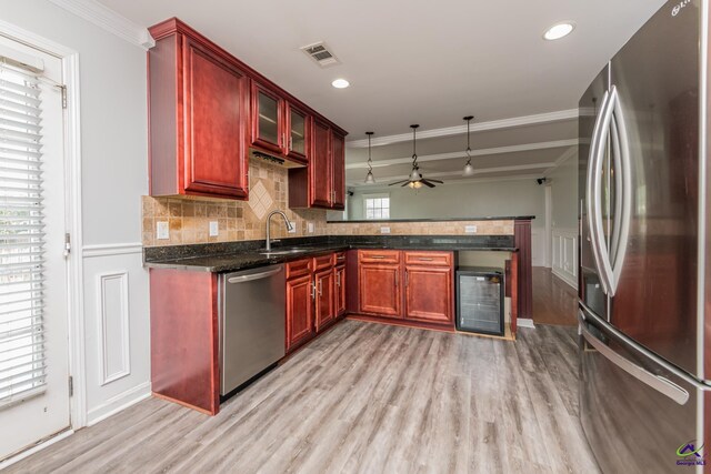 101 Bryce Dr, Warner Robins, GA 31088 - kitchen featuring a sink, beverage cooler, visible vents, stainless steel appliances, and dark brown cabinets