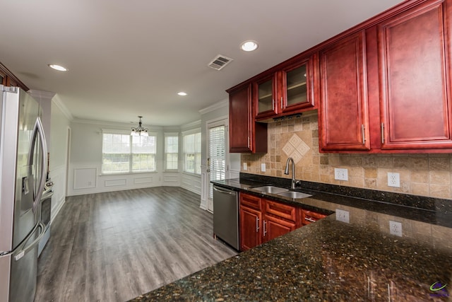 101 Bryce Dr, Warner Robins, GA 31088 - kitchen with a sink, appliances with stainless steel finishes, visible vents, dark brown cabinets, and ornamental molding