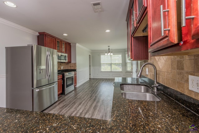 101 Bryce Dr, Warner Robins, GA 31088 - kitchen featuring a sink, appliances with stainless steel finishes, visible vents, dark brown cabinets, and ornamental molding