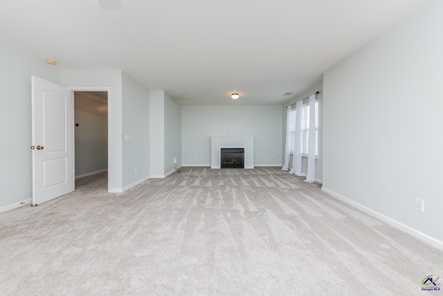 101 Bryce Dr, Warner Robins, GA 31088 - unfurnished living room with a fireplace, light colored carpet, and baseboards