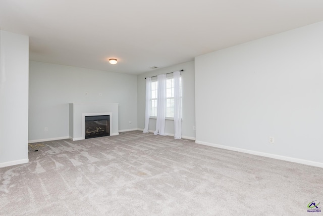 101 Bryce Dr, Warner Robins, GA 31088 - unfurnished living room with carpet flooring, baseboards, and a glass covered fireplace