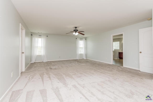 101 Bryce Dr, Warner Robins, GA 31088 - empty room featuring ceiling fan, baseboards, light colored carpet, and a healthy amount of sunlight