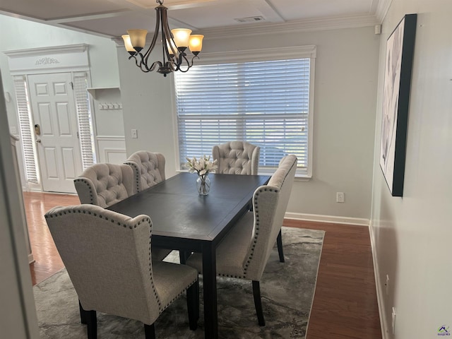 101 Bryce Dr, Warner Robins, GA 31088 - dining area with visible vents, baseboards, an inviting chandelier, wood finished floors, and ornamental molding