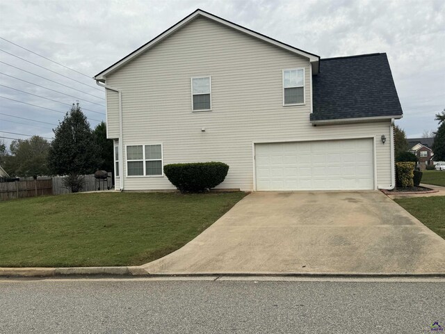 101 Bryce Dr, Warner Robins, GA 31088 - exterior space featuring fence, a lawn, driveway, and a garage