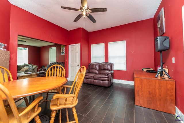 dining room with baseboards, a ceiling fan, wood finished floors, and a textured ceiling