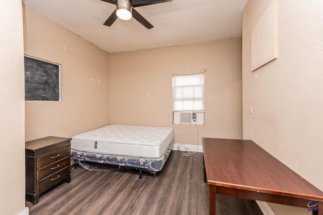 bedroom featuring cooling unit, wood finished floors, and ceiling fan