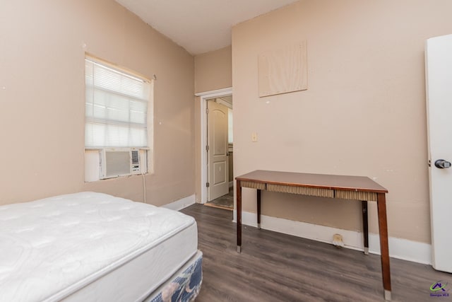 bedroom featuring wood finished floors and baseboards