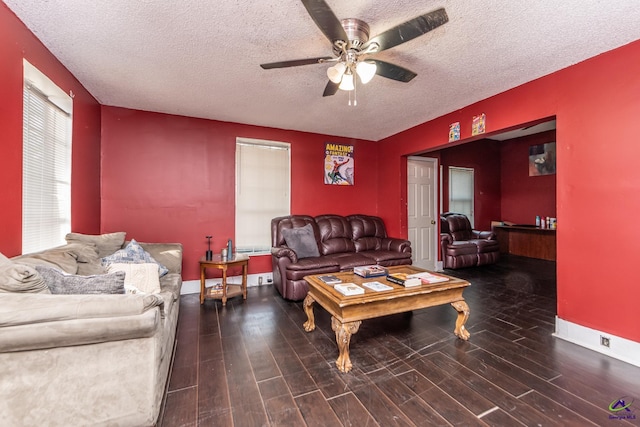 living room with wood finished floors, a textured ceiling, a ceiling fan, and baseboards