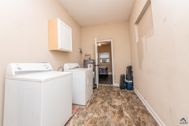laundry area featuring water heater, washer and dryer, baseboards, and cabinet space