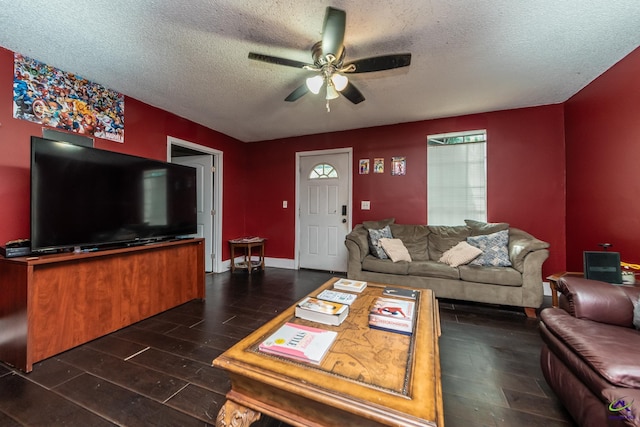 living room featuring dark wood-style flooring, a textured ceiling, and ceiling fan