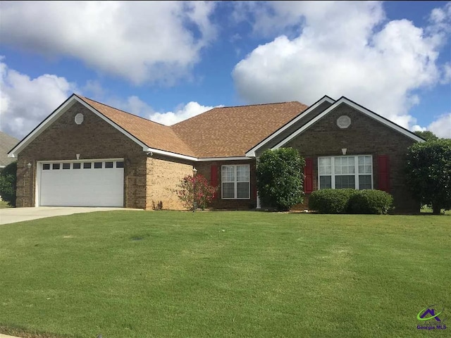 ranch-style home with brick siding, a front lawn, concrete driveway, and a garage