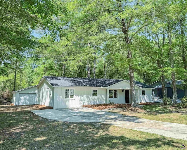 407 Frank Satterfield Rd, Perry, GA 31069 - single story home with board and batten siding, a garage, driveway, and a front lawn