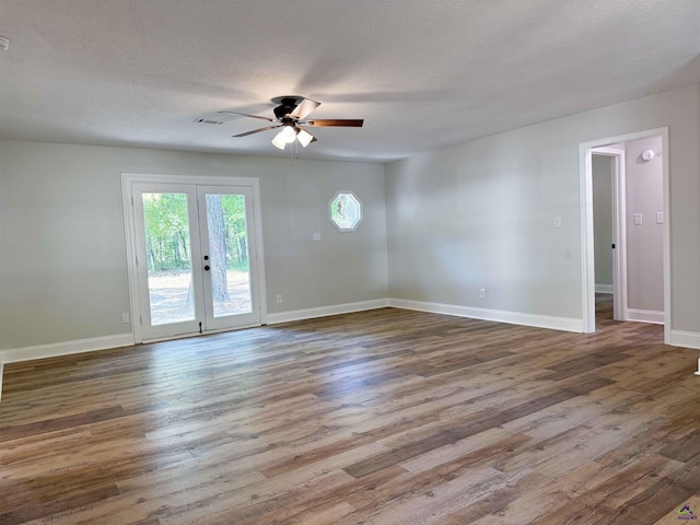 407 Frank Satterfield Rd, Perry, GA 31069 - spare room with a ceiling fan, baseboards, wood finished floors, french doors, and a textured ceiling