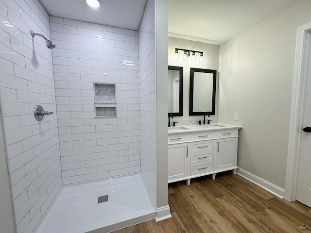 407 Frank Satterfield Rd, Perry, GA 31069 - full bathroom featuring wood finished floors, tiled shower, baseboards, and double vanity