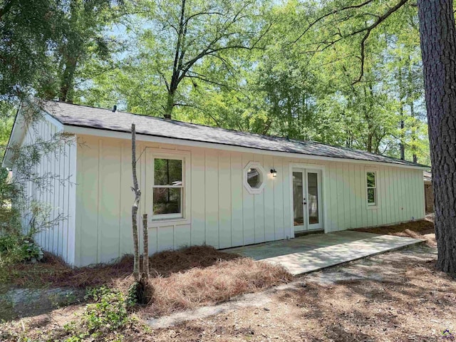 407 Frank Satterfield Rd, Perry, GA 31069 - view of front of property with french doors, a patio, board and batten siding, and roof with shingles